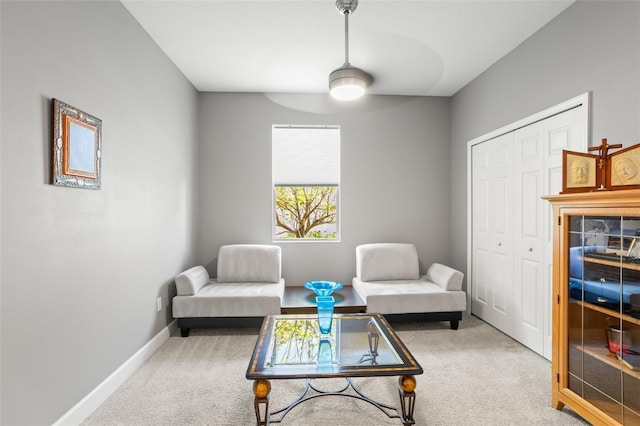 living area featuring ceiling fan and carpet floors