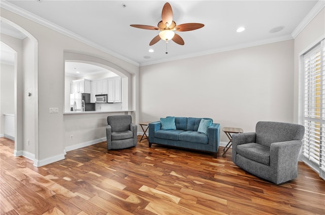 living area featuring ornamental molding, ceiling fan, and hardwood / wood-style floors