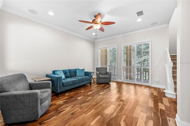 living room featuring crown molding, ceiling fan, and wood-type flooring