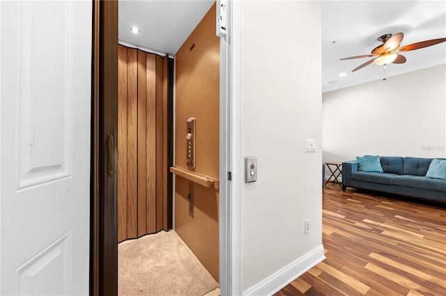 hallway with elevator and carpet floors