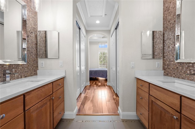 bathroom with vanity, decorative backsplash, and hardwood / wood-style flooring