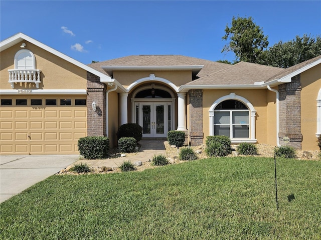 single story home featuring a garage, a front lawn, and french doors