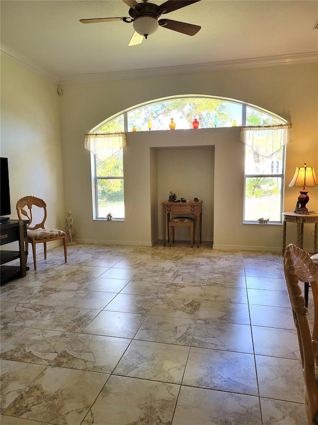 interior space with ceiling fan and ornamental molding