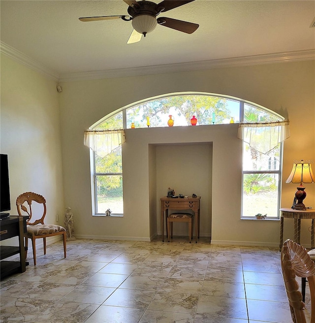 sitting room featuring ceiling fan, a wealth of natural light, and crown molding