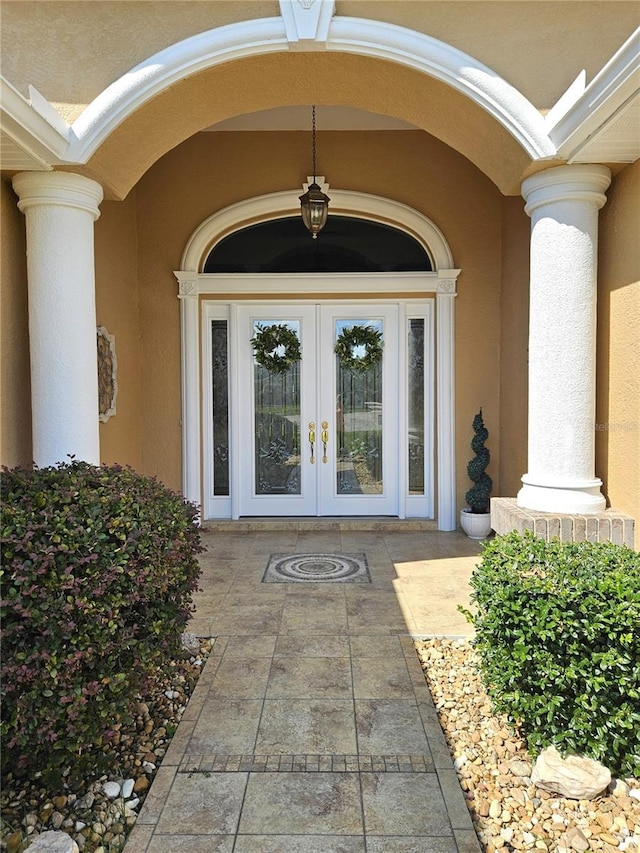 view of exterior entry featuring french doors