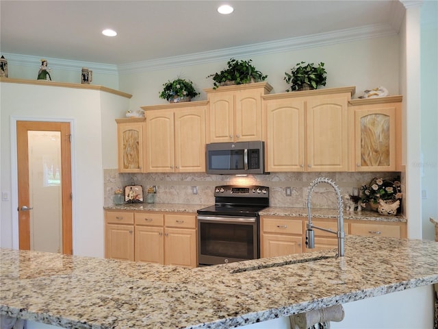 kitchen featuring appliances with stainless steel finishes, light brown cabinetry, and backsplash