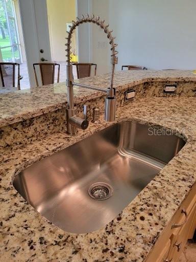 interior details with sink and light stone counters