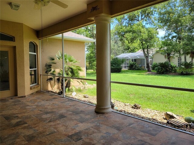 unfurnished sunroom featuring ornate columns