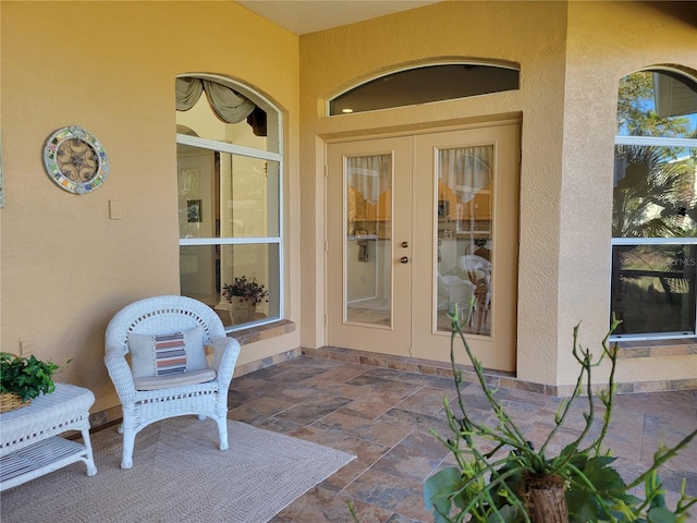 property entrance with french doors and a patio area