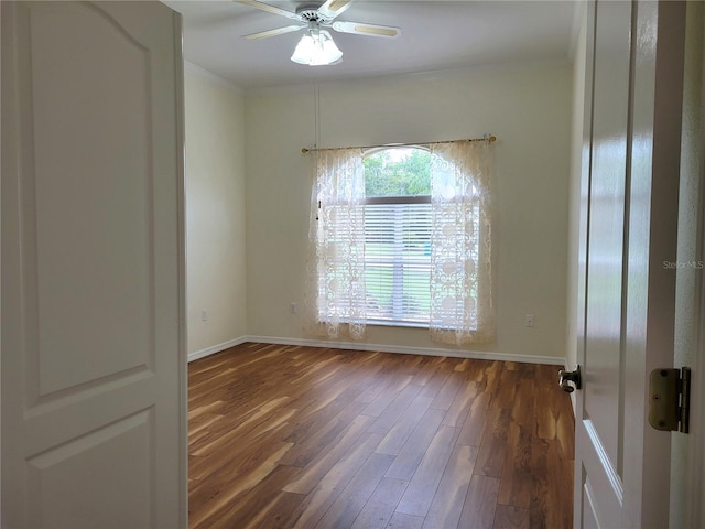 unfurnished room with ceiling fan and dark hardwood / wood-style flooring