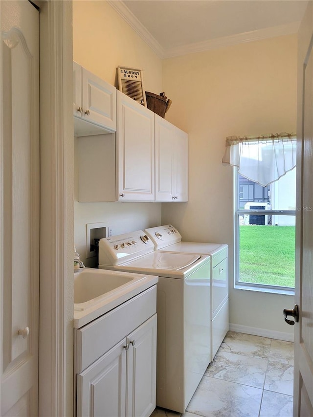 clothes washing area with cabinets, sink, ornamental molding, and independent washer and dryer