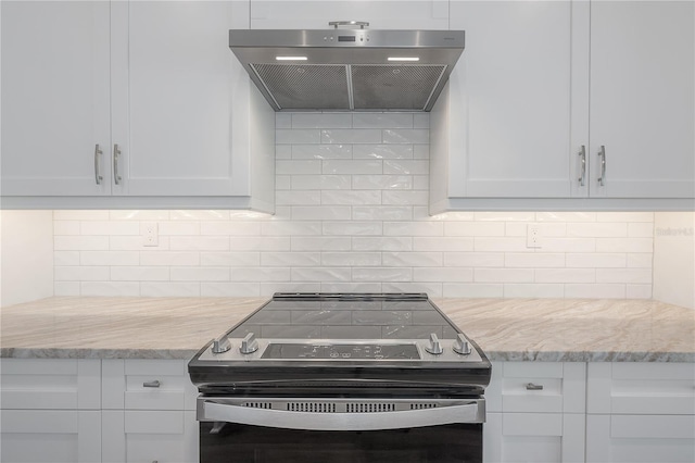 kitchen featuring white cabinets, electric stove, extractor fan, and light stone countertops