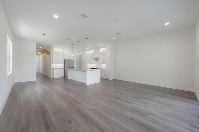 5530 N 9th St Unit 5, Tampa, FL 33604 - unfurnished living room with recessed lighting, baseboards, and wood finished floors