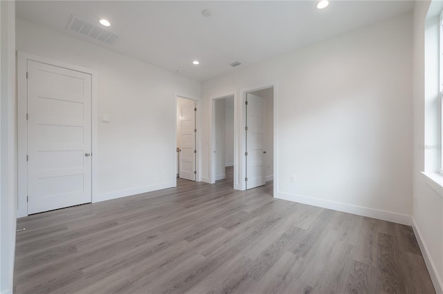 unfurnished bedroom with light wood-type flooring