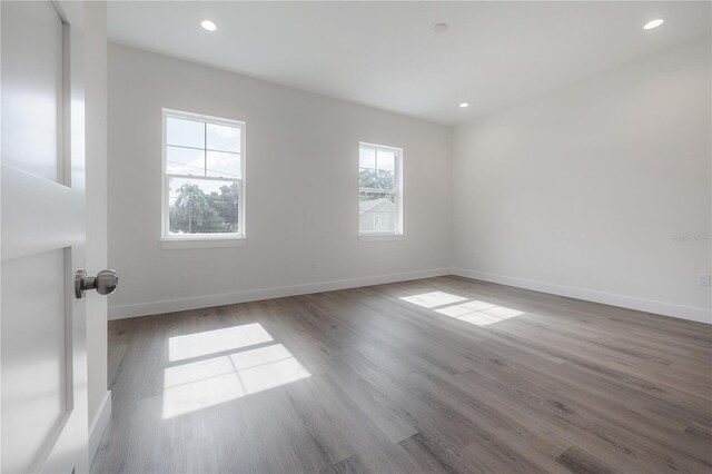 spare room with hardwood / wood-style floors