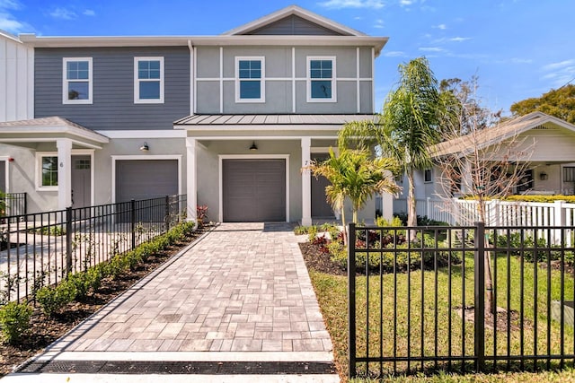 view of front of property featuring stucco siding, an attached garage, decorative driveway, and fence