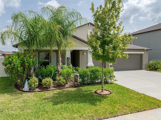 obstructed view of property with a garage and a front lawn