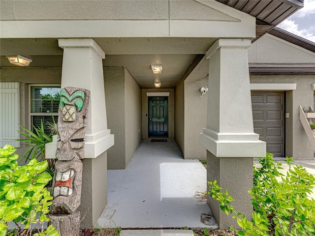 view of exterior entry with a garage