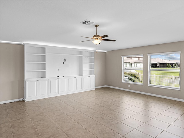 unfurnished living room with ceiling fan and built in features