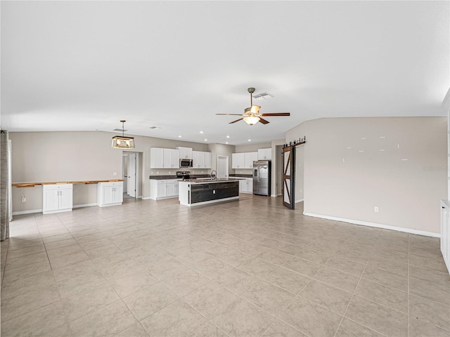 unfurnished living room with ceiling fan, lofted ceiling, and sink