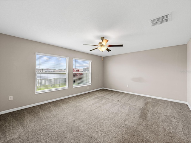 empty room with carpet floors, a textured ceiling, and ceiling fan