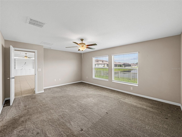 interior space with carpet floors and ceiling fan