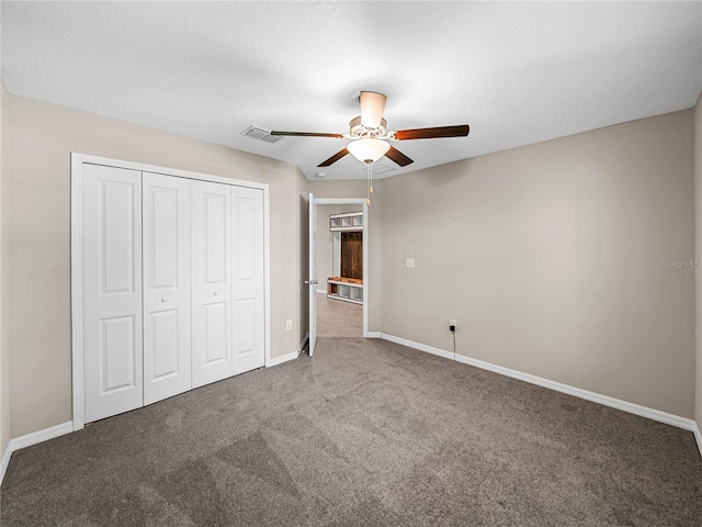 unfurnished bedroom featuring carpet floors, a closet, and ceiling fan