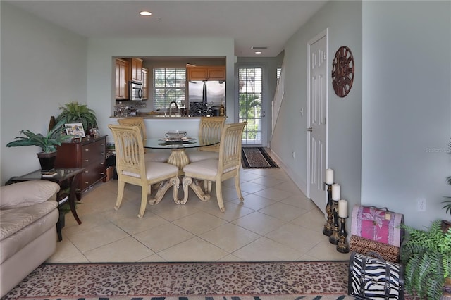 tiled dining area featuring sink