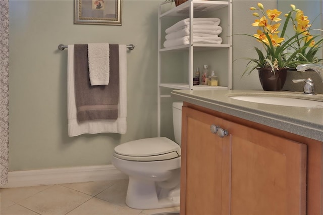 bathroom featuring tile patterned flooring, vanity, and toilet