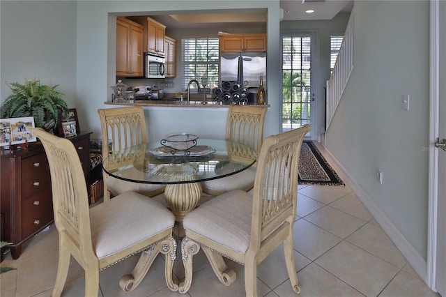tiled dining space featuring sink