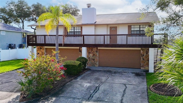 view of front of house featuring a balcony and a garage