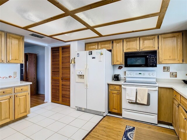 kitchen featuring light hardwood / wood-style flooring and white appliances