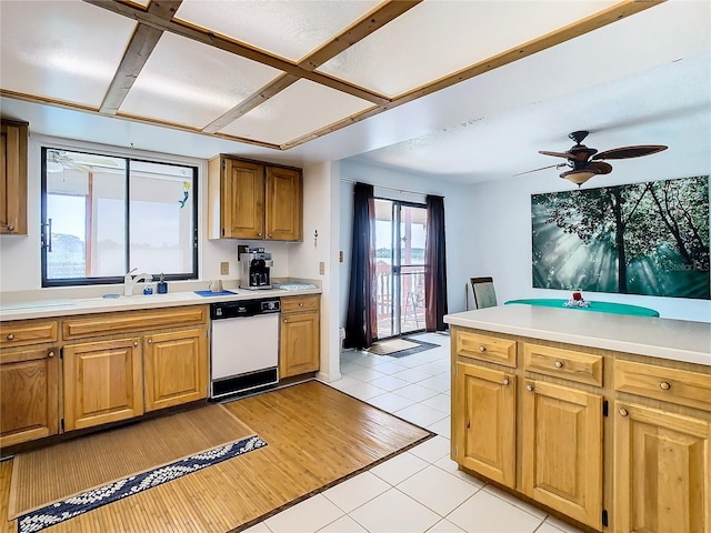 kitchen with white dishwasher, sink, light tile patterned floors, and ceiling fan