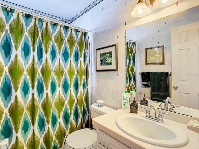 bathroom with toilet and vanity