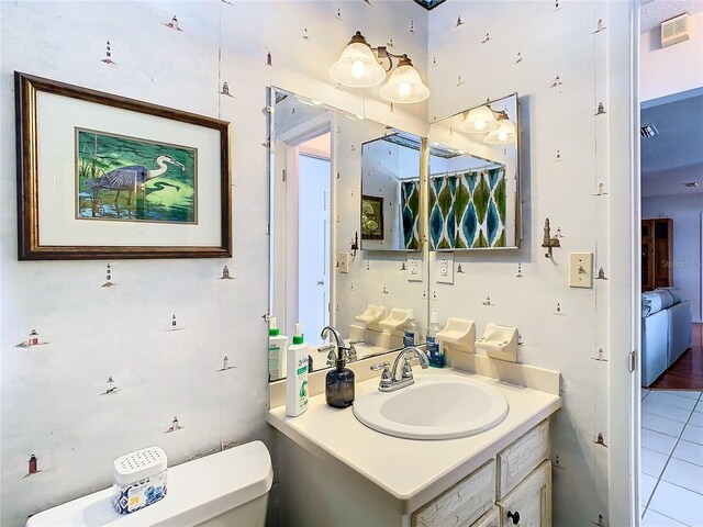 bathroom with vanity, toilet, and tile patterned flooring