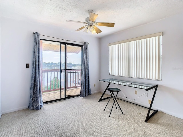 miscellaneous room featuring light colored carpet, a textured ceiling, and ceiling fan