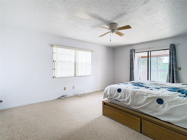 carpeted bedroom with a textured ceiling and ceiling fan