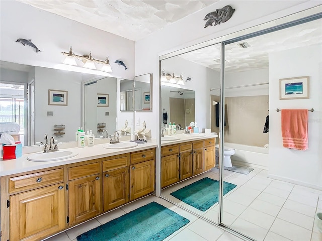 bathroom featuring double vanity, tile patterned flooring, and toilet