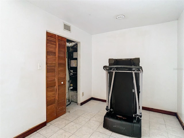 workout room featuring light tile patterned floors