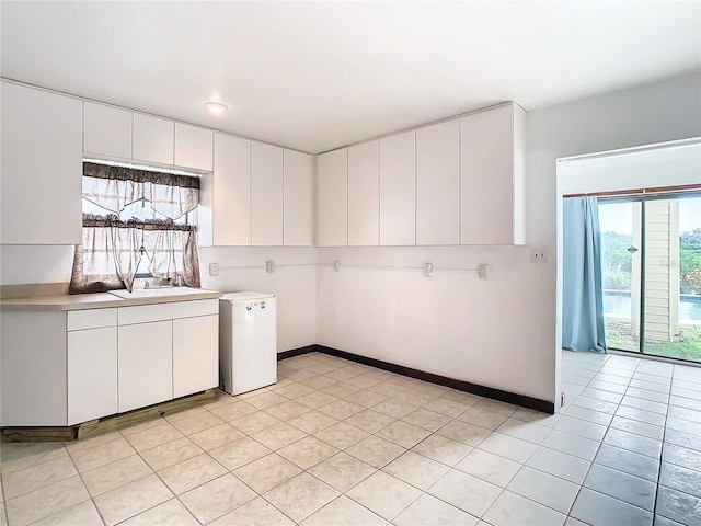 kitchen with white cabinetry and light tile patterned floors