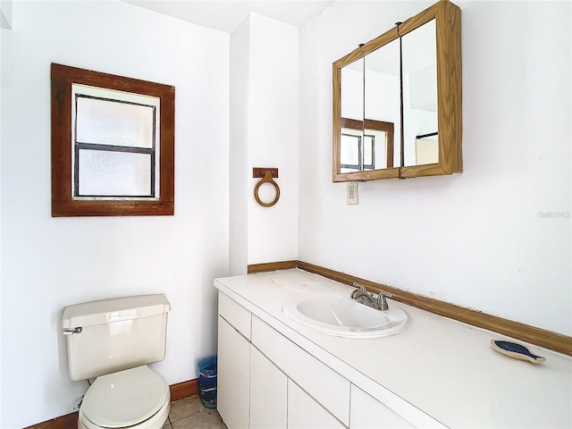 bathroom with vanity, toilet, and tile patterned flooring