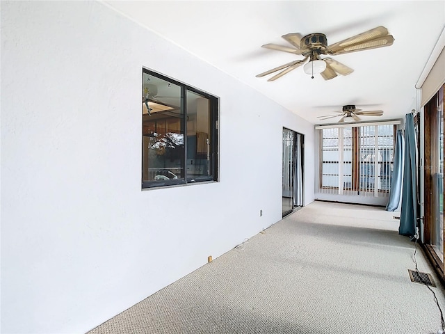 spare room with carpet and ceiling fan