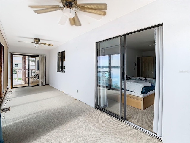 interior space with ceiling fan