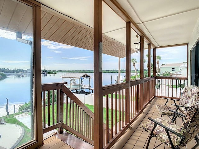 balcony with a boat dock and a water view