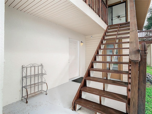 staircase featuring concrete floors