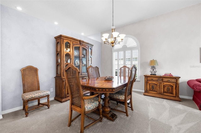 carpeted dining area with a notable chandelier