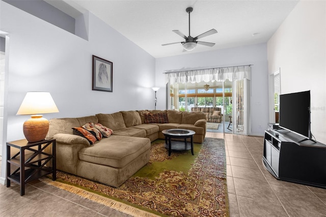 tiled living room featuring ceiling fan and a towering ceiling