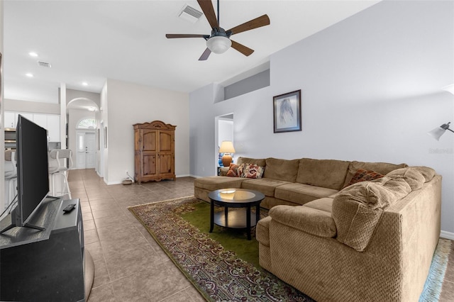 living room with ceiling fan and tile patterned flooring