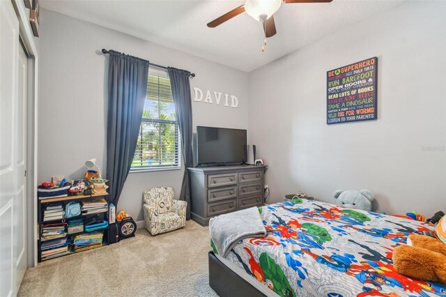 carpeted bedroom with a ceiling fan