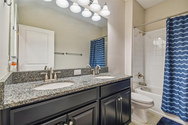 full bathroom with a sink, shower / bath combo, toilet, and double vanity
